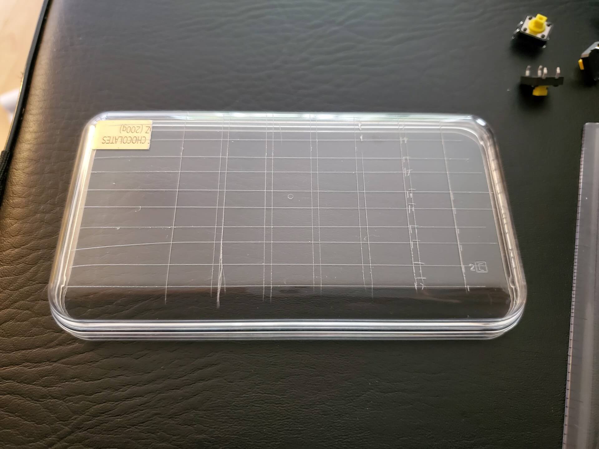 Plastic box lid marked with a knife